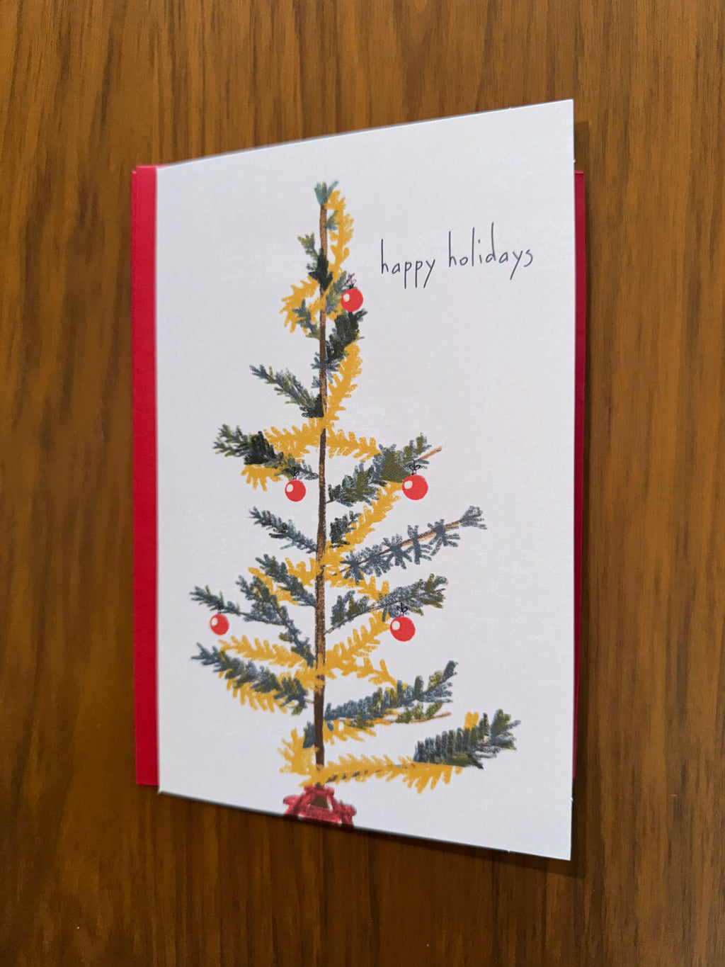 Holiday card with a Christmas tree design and 'happy holidays' 